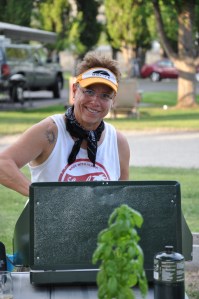 Chef Kim cooking it up in the 90 degree heat. She must love it.